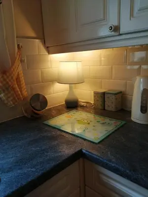 a lamp sitting on top of a kitchen counter at Marjorie's Cottage in Ulverston