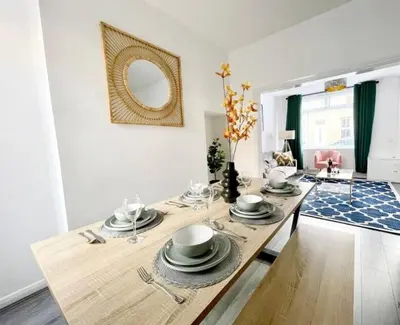 a dining room with a table and a mirror at Residency serviced accomodation liverpool in Litherland