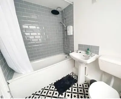 a bathroom with a sink and a tub and a toilet at Residency serviced accomodation liverpool in Litherland