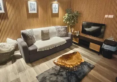a living room with a couch and a tv at Manhattan Suites Near Liverpool ONE sleeps 4 in Liverpool