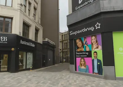 a building with an advertisement on the side of a street at Manhattan Suites Near Liverpool ONE sleeps 4 in Liverpool