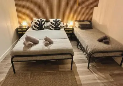 two beds in a small room with two at Manhattan Suites Near Liverpool ONE sleeps 4 in Liverpool