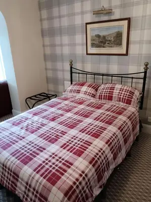 a red and white plaid bed in a bedroom at Sea View in Heysham