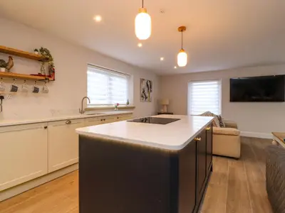a kitchen with a sink and a counter top at Treetops in Newton