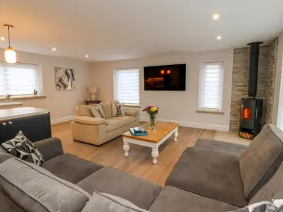 a living room with two couches and a fireplace at Treetops in Newton