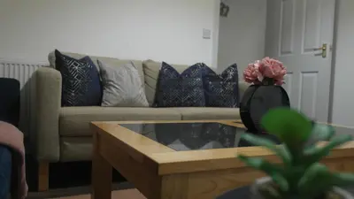 a living room with a couch and a coffee table at Newly Renovated 3 Bedroom House, 6 beds with 2 showers, near University Town Centre in Lancaster