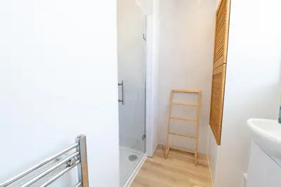 a bathroom with a shower and a sink and a toilet at Terracotta Apartment, free WiFi & parking, coastal location in New Brighton