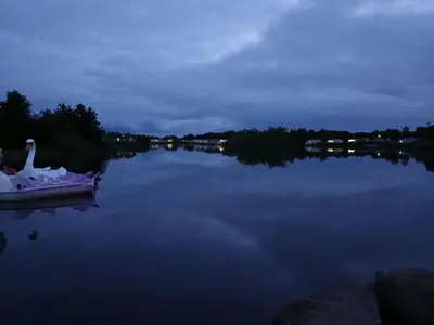 a swan on a boat on a lake at night at 3-Bed Caravan - Haven Lakeland Leisure Park in Grange Over Sands