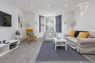 a living room with a couch and a table at Lytham St Annes Luxury Apartment - No 2 Tides Reach in Lytham St Annes