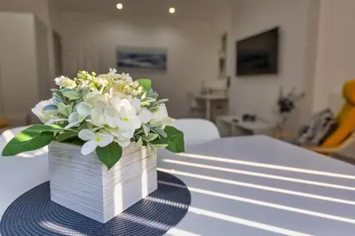 a vase of flowers sitting on top of a table at Lytham St Annes Luxury Apartment - No 2 Tides Reach in Lytham St Annes