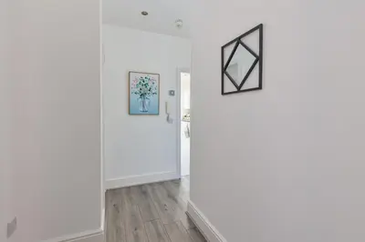 a room with white walls and a door and a picture at Lytham St Annes Luxury Apartment - No 2 Tides Reach in Lytham St Annes