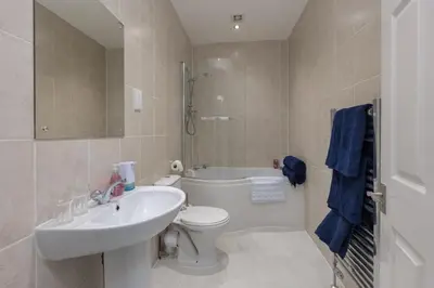 a bathroom with a sink and a toilet and a shower at Lytham St Annes Luxury Apartment - No 2 Tides Reach in Lytham St Annes