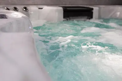 a bath tub filled with green water and snow at Grand Victorian Villa 6 - En-Suites, Hot Tub, Cinema Room, Private Parking & Park View in Liverpool