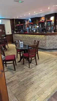 a restaurant with a table and chairs and a bar at Lake View - Beacon Fell View Holiday Park in Longridge