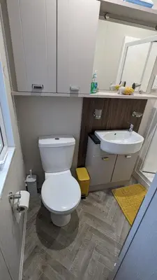 a bathroom with a white toilet and a sink at Lake View - Beacon Fell View Holiday Park in Longridge
