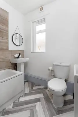 a white bathroom with a toilet and a sink at Residency apartments Liverpool in Liverpool