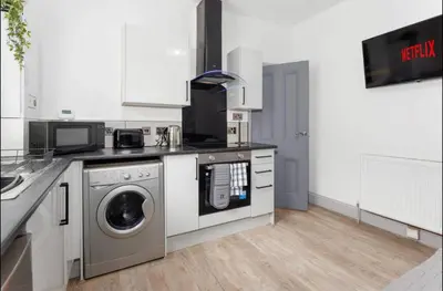 a kitchen with a washing machine and a washer at Residency apartments Liverpool in Liverpool