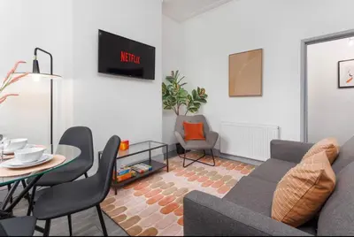 a living room with a couch and a table at Residency apartments Liverpool in Liverpool