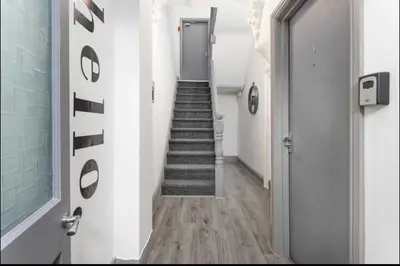a hallway with a stairway with a door and a stairwayngth at Residency apartments Liverpool in Liverpool