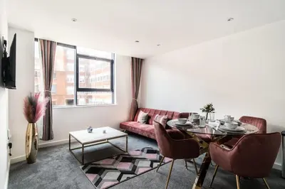 a living room with a red couch and a table at Lovely 1 Bed Central Preston Apartment in Preston