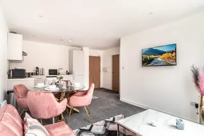 a living room with a table and chairs at Lovely 1 Bed Central Preston Apartment in Preston