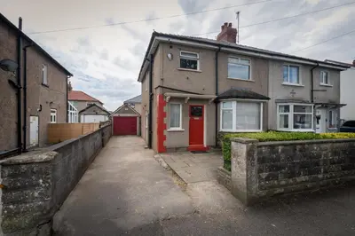 a house with a red door on a street at Entire House at Buckingham Road in Morecambe