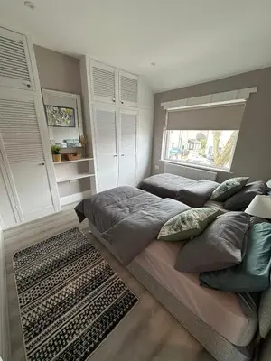 a bedroom with a large bed and a window at Entire House at Buckingham Road in Morecambe