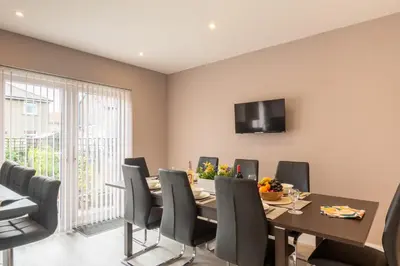 a dining room with a table and chairs at Entire House at Buckingham Road in Morecambe