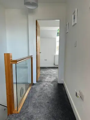 an empty room with a door and a hallway with a glass doorway at Clock Tower Apartment No4 in Morecambe