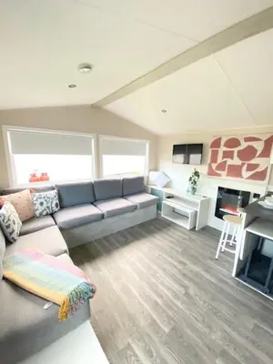 a living room with a couch and a fireplace at Haven, Cala Gran caravan park, privately owned in Blackpool