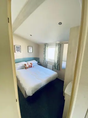a bedroom with a large bed in a room at Haven, Cala Gran caravan park, privately owned in Blackpool