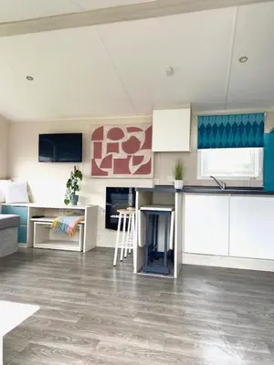 a living room with a kitchen with a counter top at Haven, Cala Gran caravan park, privately owned in Blackpool