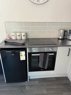 a kitchen with a stove and a counter top at Goldie's Retreat in Blackrod