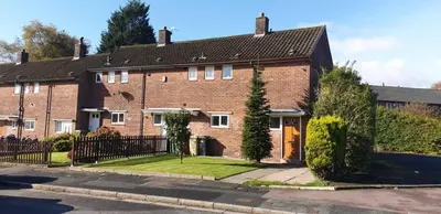 a large brick house with a black fence at Cosy Single Room l Smart TV l 5 Minute Walk from Train Station in Bolton