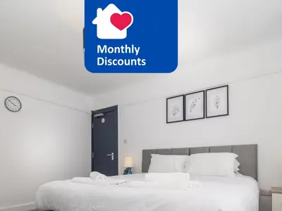 two beds in a bedroom with a sign that reads maturity discounts at 3BR Haven Retreat in Wallasey with FREE Street Parking in Wallasey