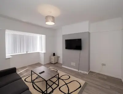 a living room with a couch and a table at 3BR Haven Retreat in Wallasey with FREE Street Parking in Wallasey
