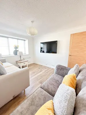 a living room with a couch and a tv at Stylish Modern Apartment in Blackpool with Parking in Blackpool