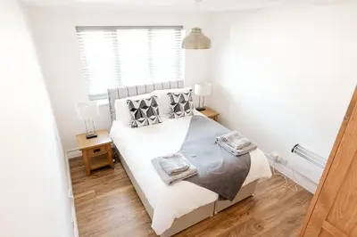 a bedroom with a bed and a window at Stylish Modern Apartment in Blackpool with Parking in Blackpool
