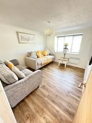 a living room with a couch and a table at Stylish Modern Apartment in Blackpool with Parking in Blackpool