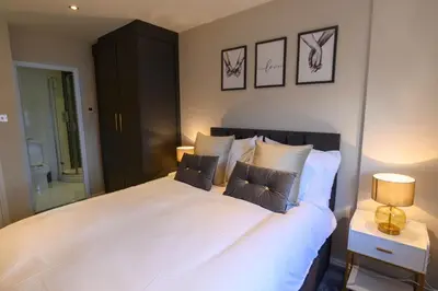 a bedroom with a large white bed with two pillows at Stunning Liverpool City Location with River View and parking space included in Liverpool
