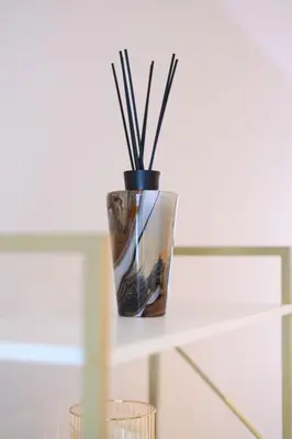 a vase with sticks in it sitting on a shelf at Stunning Liverpool City Location with River View and parking space included in Liverpool