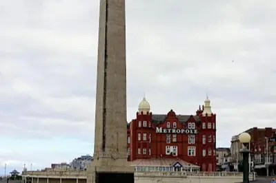 a large building in front of a tall building at Seaside - House - Sleeps 10 - Parking - Garden in Blackpool