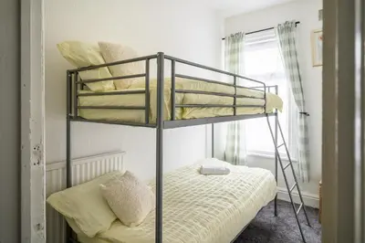 a bunk bed in a small room with a bunk bedutenewayangering at Seaside - House - Sleeps 10 - Parking - Garden in Blackpool