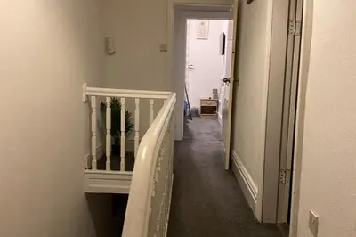 a hallway with a stairway leading into a room at Seaside - House - Sleeps 10 - Parking - Garden in Blackpool