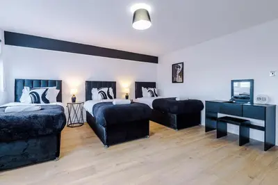 a large bedroom with two beds and a couch at #6 - Vibrant apartment in City Centre - Sleeps 7 - Exclusive offers at a-kapartments in Liverpool