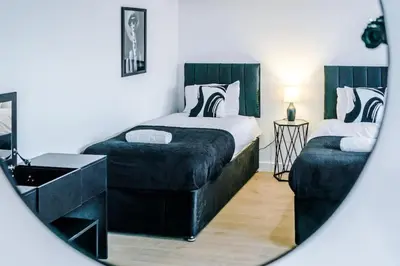 a bedroom with a bed and a sink and a mirror at #6 - Vibrant apartment in City Centre - Sleeps 7 - Exclusive offers at a-kapartments in Liverpool