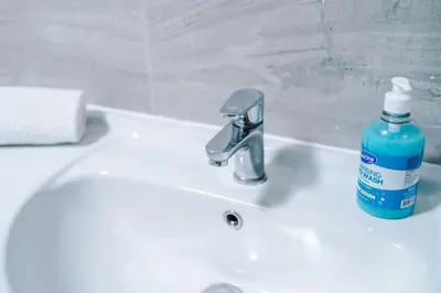 a bathroom sink with a blue soap bottle on it at #6 - Vibrant apartment in City Centre - Sleeps 7 - Exclusive offers at a-kapartments in Liverpool