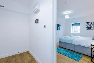 a bedroom with a bed and a room with a doorway at #6 - Vibrant apartment in City Centre - Sleeps 7 - Exclusive offers at a-kapartments in Liverpool