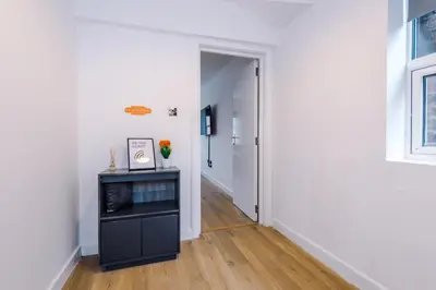 a hallway with a white wall and a door at #6 - Vibrant apartment in City Centre - Sleeps 7 - Exclusive offers at a-kapartments in Liverpool