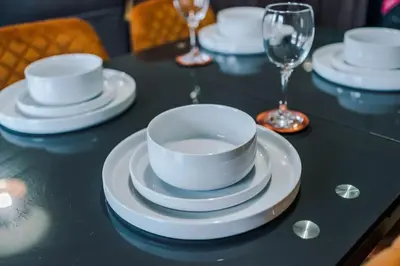 a table with white plates and cups and wine glasses at #6 - Vibrant apartment in City Centre - Sleeps 7 - Exclusive offers at a-kapartments in Liverpool